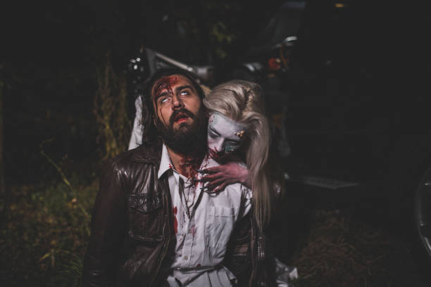 Witch attacked a man at night Man and woman, she masked herself in a scary witch for Halloween, attacking a man. male vampire biting his victim stock pictures, royalty-free photos & images