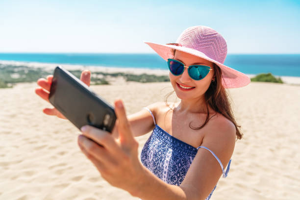 istock Beautiful woman taking selfie on the beach. 1176532452