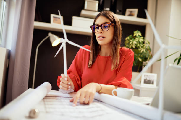 istock Businesswoman holding windmill model. 1176533186