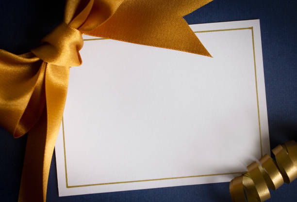 Blank card with gold ribbon A blank card with gold ribbons on a blue background christmas card photos stock pictures, royalty-free photos & images