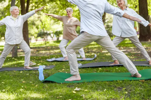 Pensioners doing chi kung exercises outdoors stock photo