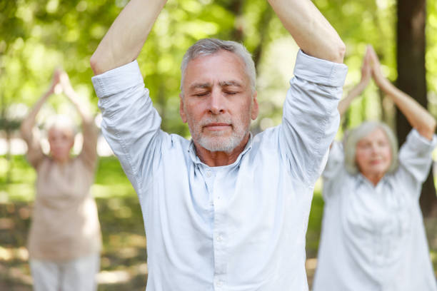 istock Serene mature man doing qigong exercise in the park 1176536145