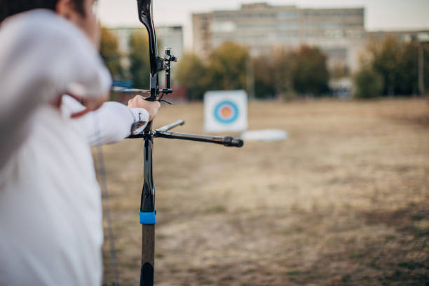 istock Man archer aiming at target outdoors 1176536361