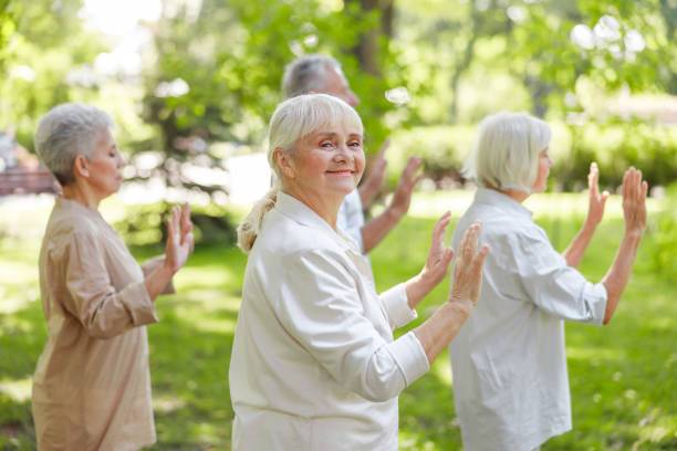 istock Joyful senior lady practicing qigong with friends 1176536531