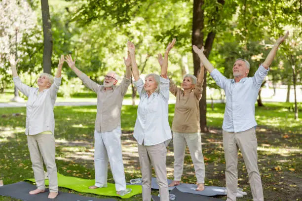 Adult people doing exercise outdoors