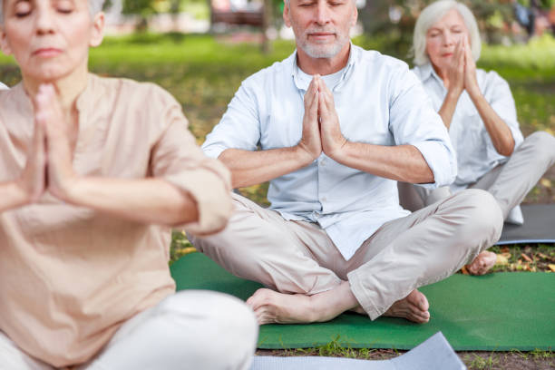 istock Senior people doing chi kung meditation exercise outdoors 1176538264