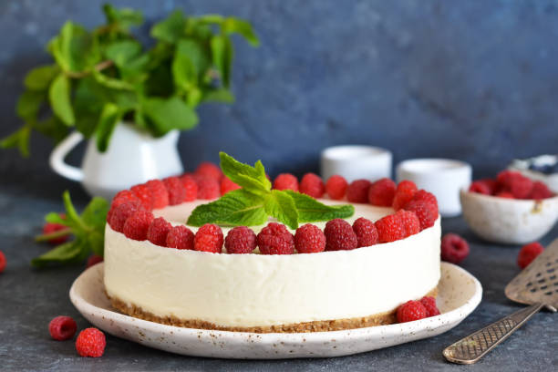 istock Vanilla cheesecake with raspberries on a stone background. New York cheesecake with raspberries. 1176539491