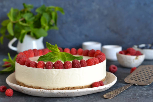 istock Vanilla cheesecake with raspberries on a stone background. New York cheesecake with raspberries. 1176539501