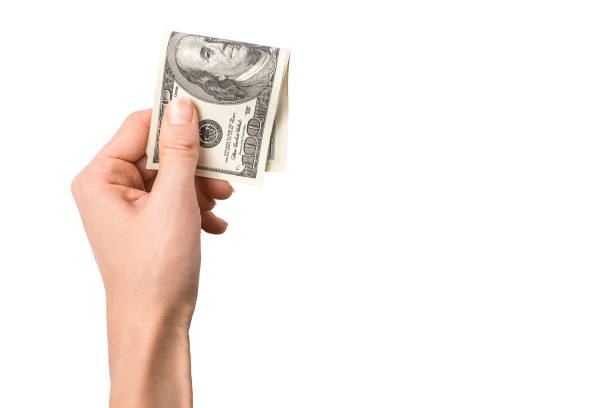 istock Dollars in woman hand isolated on white background. 1176540431