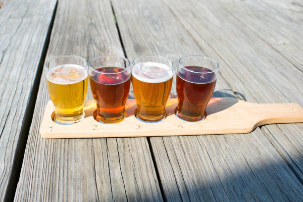 Beer flight of craft beers at outdoor beer tasting event in Finger Lakes, Upstate New York Beer tasting in US lake seneca stock pictures, royalty-free photos & images