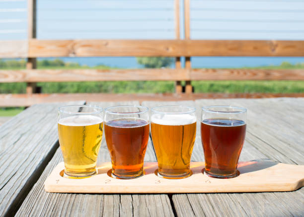 Beer flight of craft beers at outdoor beer tasting event in Upstate New York Beer tasting in US lake seneca stock pictures, royalty-free photos & images