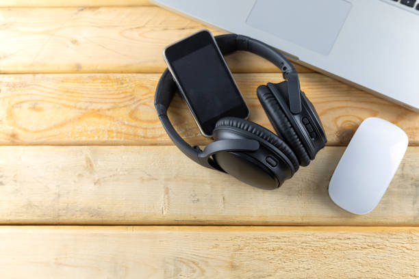 istock Headphone, Keybord, Mouse and music portable on wood table with copy space for text or design. 1176542720