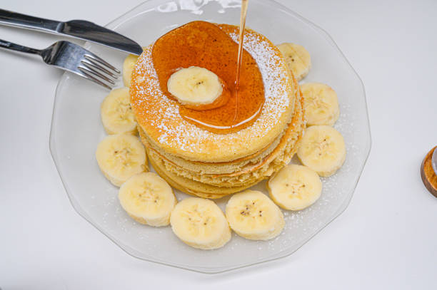 Pancake banana with plate on the table.