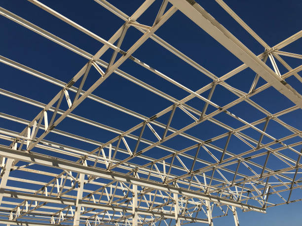 istock Truss ceiling and metal pillars and girders. Support constructions. Industrial building metal framework 1176545037