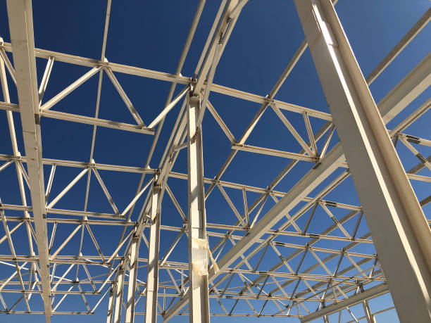 istock Truss ceiling and metal pillars and girders. Support constructions. Industrial building metal framework 1176545889