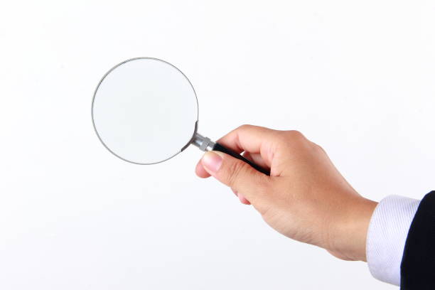 Woman hand holding magnifying glass on white background