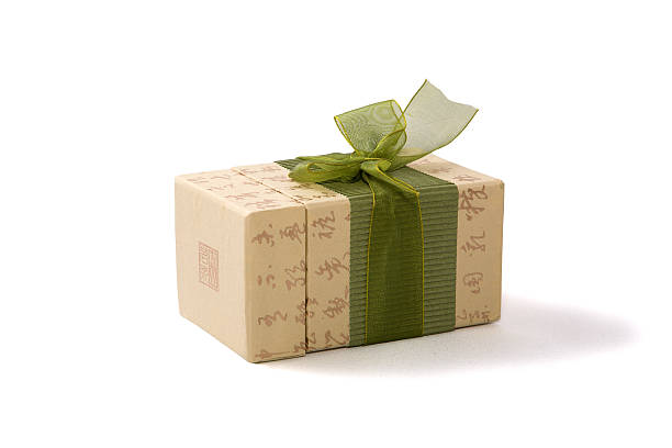 Gift box in asian style with hierogyiphs and green ribbon stock photo