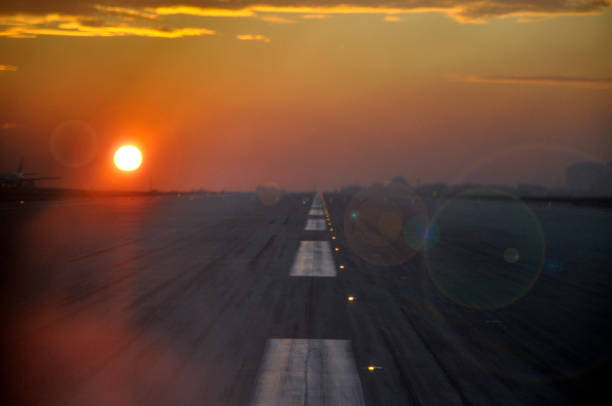 After landing runway view from cockpit window at sunset.