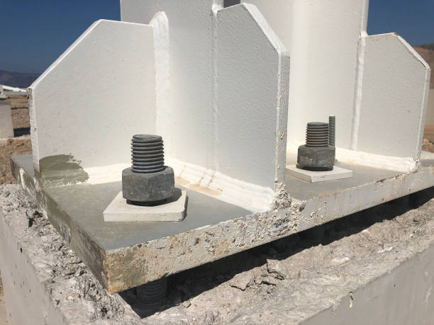 istock Metal pillar fasten to basement with anchor bolts and nuts. Supporting structures, metal frame of prefabricared building 1176554131