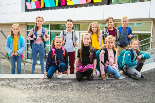 istock group of kids on the school background having fun 1176554322