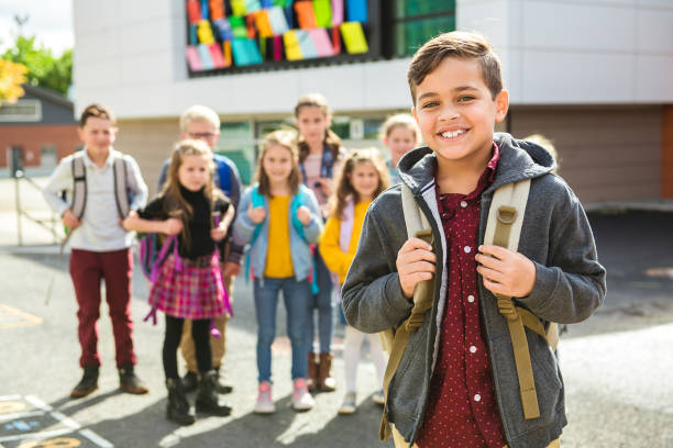 istock A portrait of young hispanic student in front of a group 1176554434