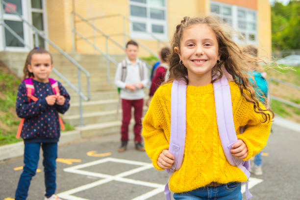 istock A schoolgirl walking with other student on the back 1176555562