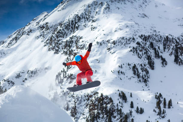 istock Man Snowboarding On Snowcapped Mountain 1176555843