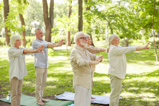 istock Group of old people doing chi kung exercise in the park 1176556897
