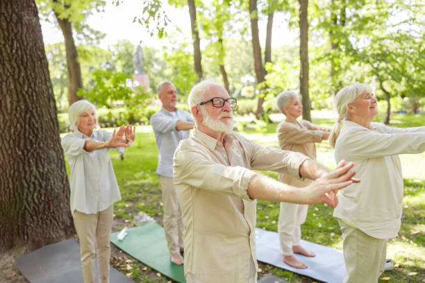 istock Smiling old people doing chi kung meditation exercise outdoors 1176556914