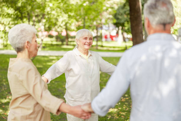 istock Joyful elderly people practicing chi kung in the park 1176556982