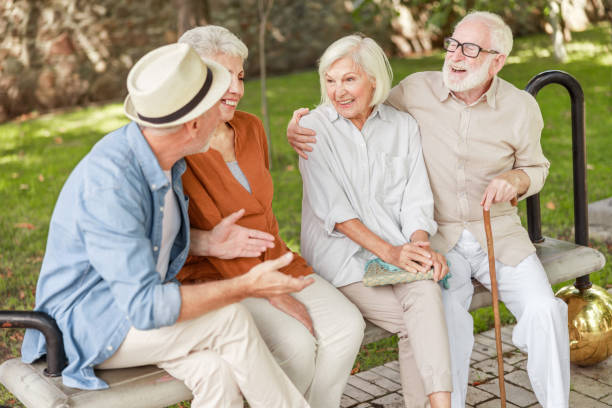 istock Joyful senior people chatting and laughing outdoors 1176557401