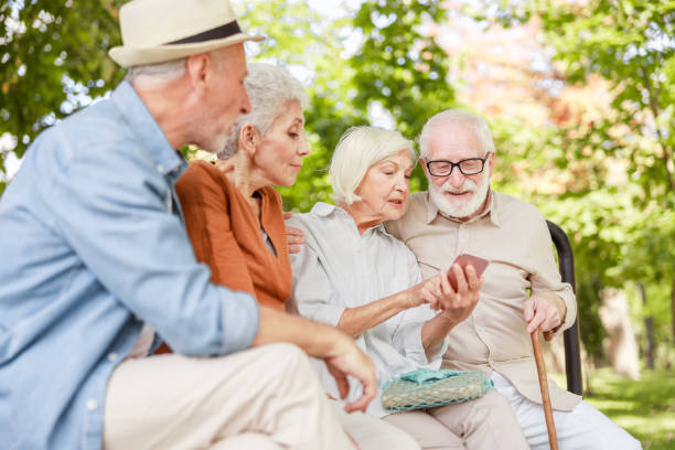 istock Senior people using modern cellphone on the street 1176557413