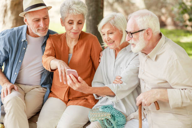istock Joyful senior people using mobile phone on the street 1176557469