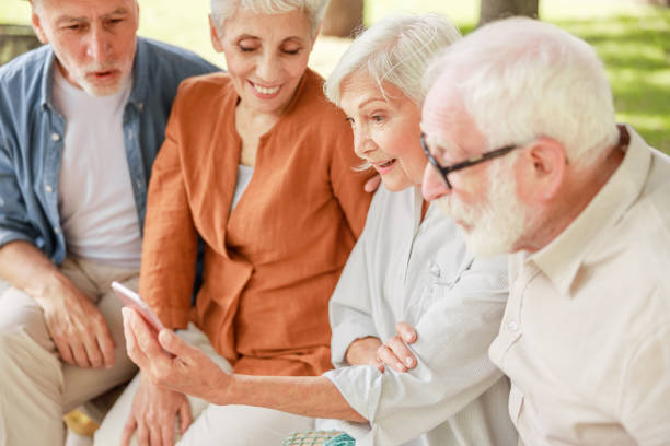 istock Group of senior people using smartphone on the street 1176557482