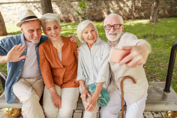Joyful senior people making selfie on the street
