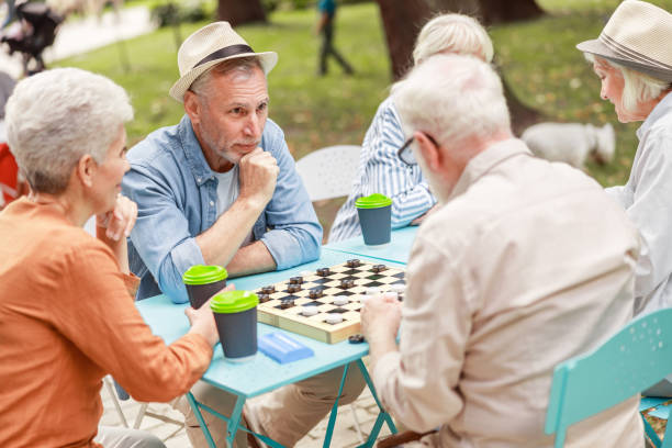 istock Old gentlemen playing checkers in the park 1176557586