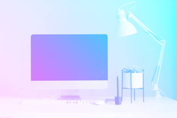 istock White office desk table with computer keyboard, mouse, monitor, graphic tablet, smartphone, succulent plant and office supplies in trendy neon colors. Rainbow gradient background with copy space 1176558844