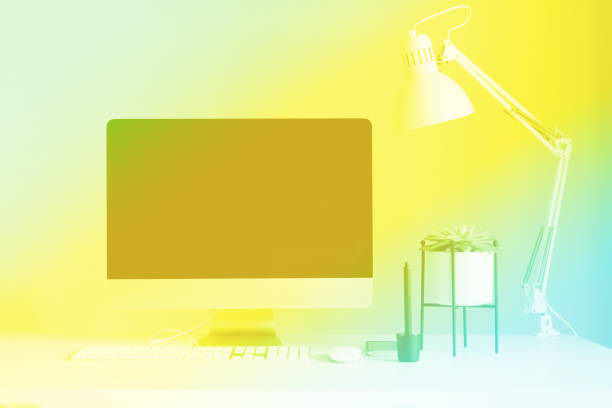 istock White office desk table with computer keyboard, mouse, monitor, graphic tablet, smartphone, succulent plant and office supplies in trendy neon colors. Rainbow gradient background with copy space 1176558871