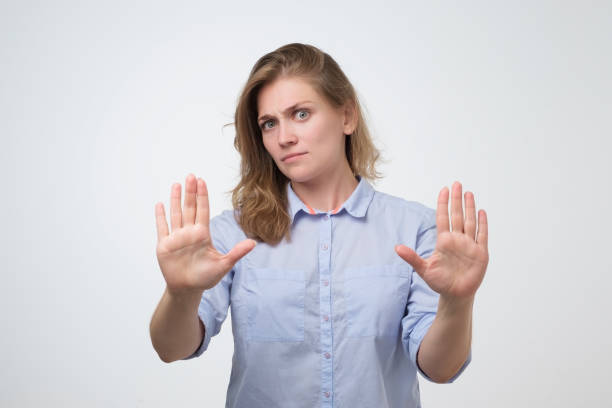 istock Woman showing stop or enough gesture with hand, frowning 1176559046