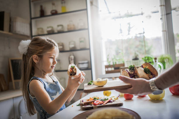 istock Father And Daughter In Kitchen At Home Making tortillas 1176559169