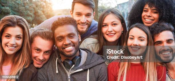 Happy Millennial Friends From Diverse Cultures And Races Having Fun Posing In Front Of Smartphone Camera Youth And Friendship Concept Young Multiracial People Smiling Main Focus On African Man Stock Photo - Download Image Now