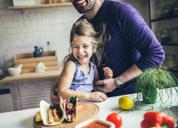 istock Father And Daughter In Kitchen At Home Making tortillas 1176560341