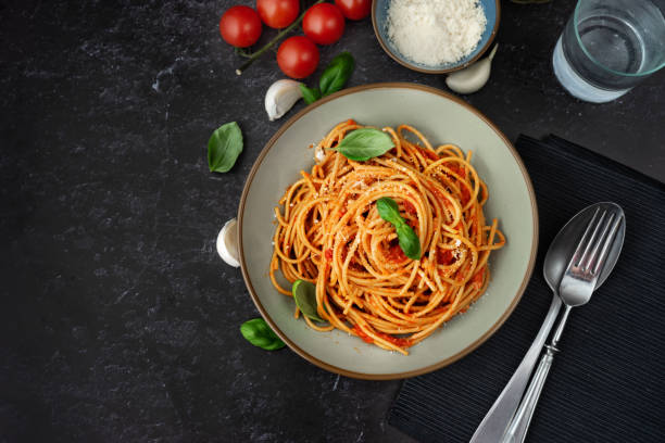 istock Pasta with tomato sauce on black background 1176560587