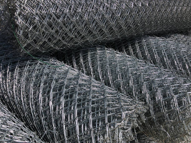 istock Rolled chain-link fence. Metal mesh netting rolled into rolls 1176562099