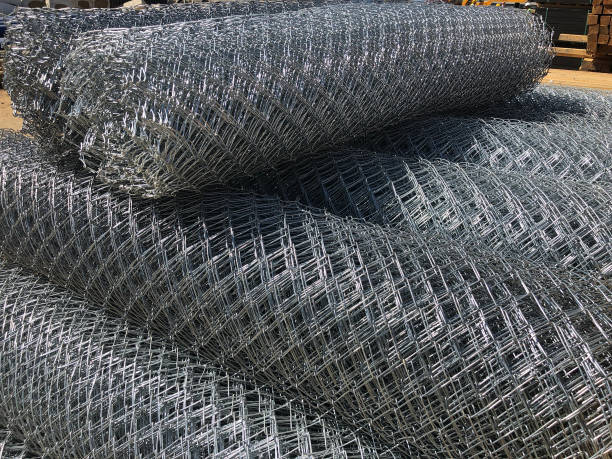 istock Rolled chain-link fence. Metal mesh netting rolled into rolls 1176562295
