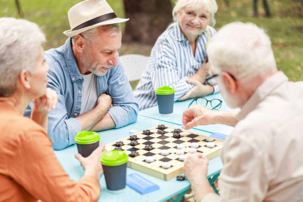 istock Senior people playing checkers in the park 1176562359