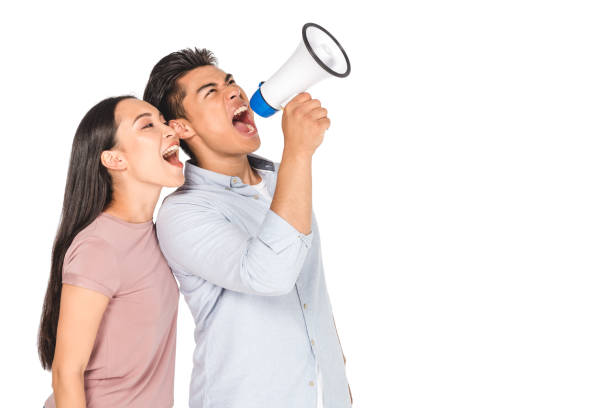 istock young asian couple screaming into megaphone together isolated on white 1176567166