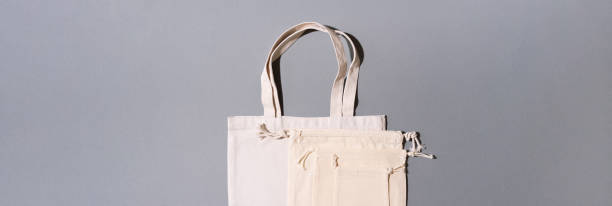 istock Canvas tote bag canvas and linen fabric bags with drawstring on grey background with copy space. Top view. Zero waste, plastic free concept. Eco friendly shopper. 1176569279