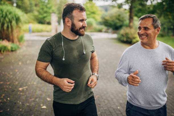 istock Father and son jogging in park 1176569555