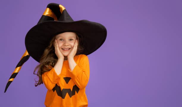 istock little witch on purple background 1176569825